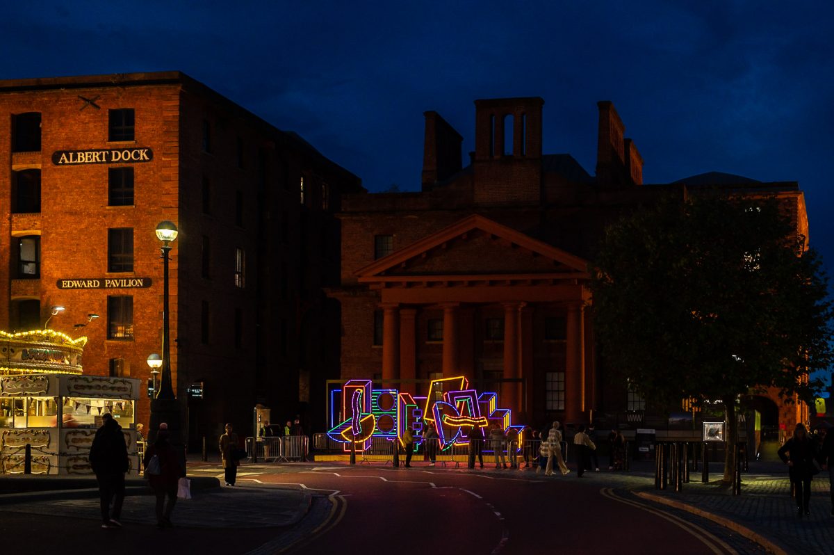 Lighting installation comprising of various colourful shapes lit up at dusk outside the Martin Luther King building.