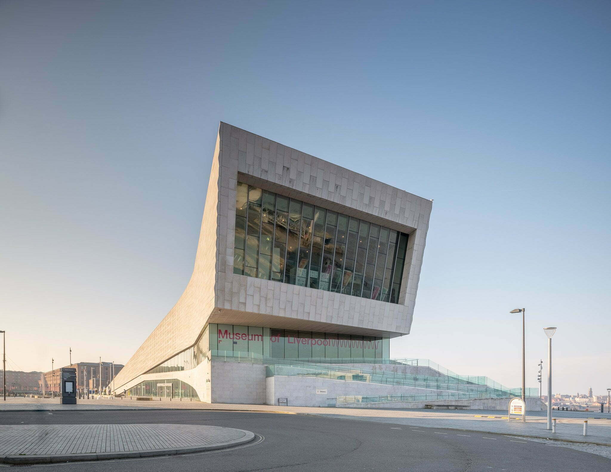 Wide view of the Museum of Liverpool from across the road. It is a sunny day with no clouds in the sky.