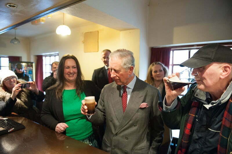 Prince Charles enjoys a beer in Toxteth, Liverpool.