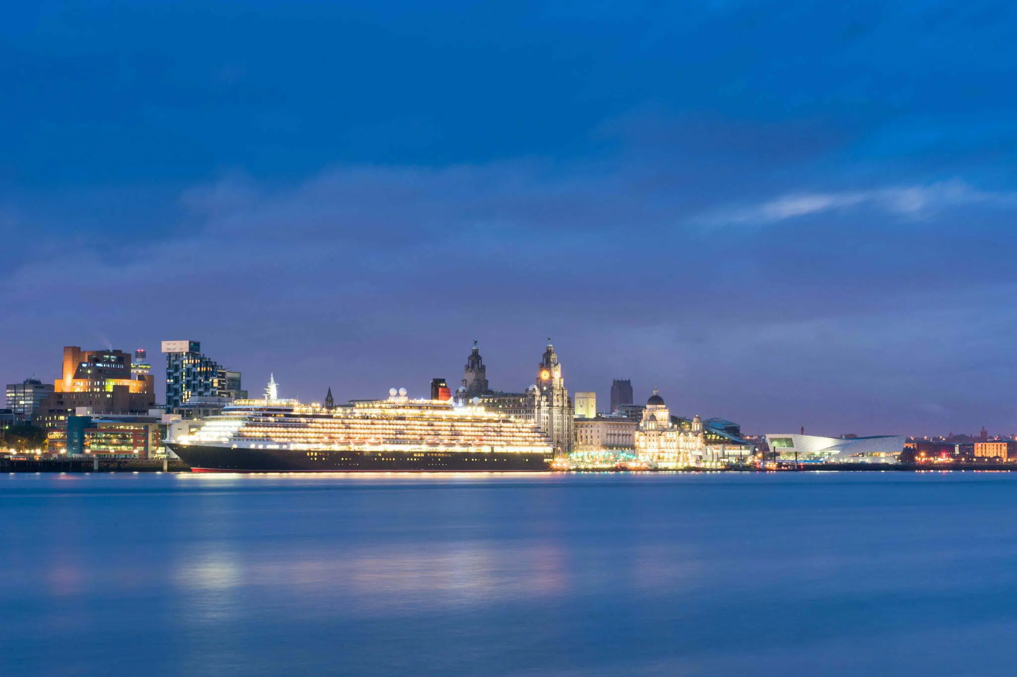 Queen Victoria docked against the Liverpool skyline
