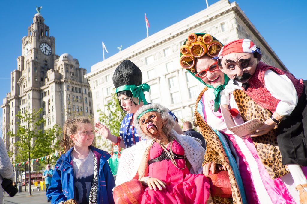 Street theatre performers put on a show for the family featuring puppets outside the Cunard building.
