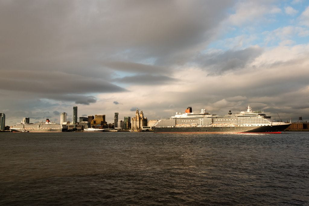 2 Cunard ships in the River Mersey in evening light.
