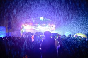 Torrential rain makes it nearly impossible to make out the stage at Bluedot Festival.