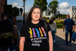 A woman wearing a 'Positive Vibes Only' t-shirt at Liverpool Pride.