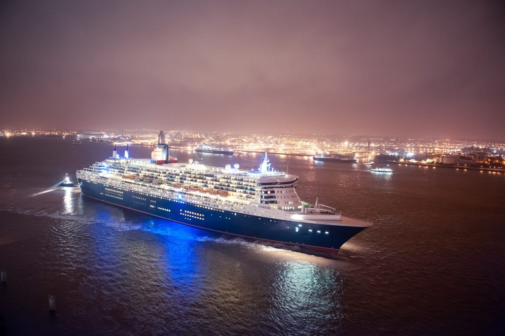 Cunard's Queen Mary 2 cruise liner on its inaugural visit to Liverpool at night.